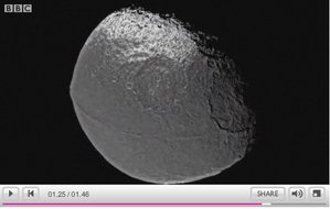 The moon that moves through the ring, Iapetus, dark on one side, light on the other.