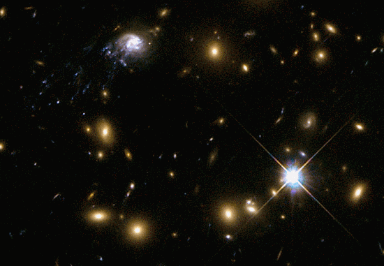 The Comet Galaxy (upper left) in galaxy cluster Abell 2667. Credit: NASA, ESA, Jean-Paul Kneib (Laboratoire d'Astrophysique de Marseille)