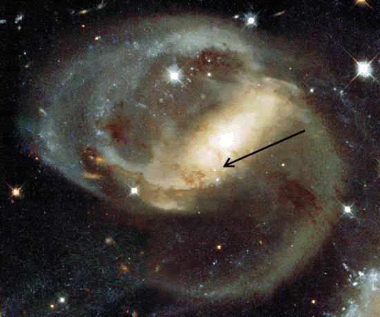 Galaxy NGC 7319. Arrow points to foreground high redshift quasar. Credit: NASA/Hubble Space Telescope
