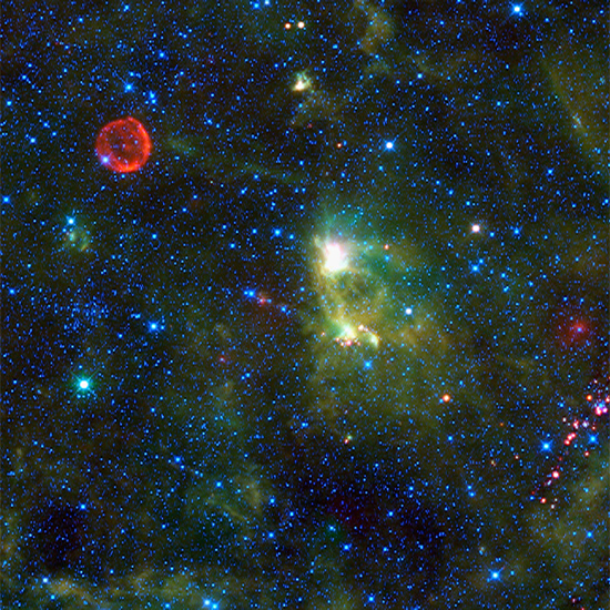 Composite wide-field infrared image, with SN1572 (Tycho Supernova Remnant) upper left. Blue and cyan indicate infrared wavelengths of 3.4 and 4.6 microns, while green and red show objects radiating at 12 and 22 microns. Credit: NASA/JPL-Caltech/WISE Team.