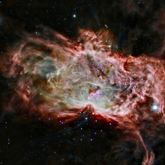 A star cluster in the center of the Flame Nebula about 1,400 light years from Earth.